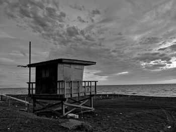 Lifeguard hut on beach against sky