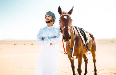 Man with horse on desert