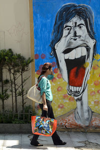 Close-up of woman standing against wall