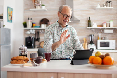 Man having food on table at home