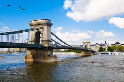 View of bridge over river against cloudy sky