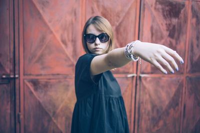 Close-up of young woman showing fingernails with nail polish