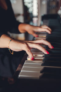 Midsection of woman playing piano