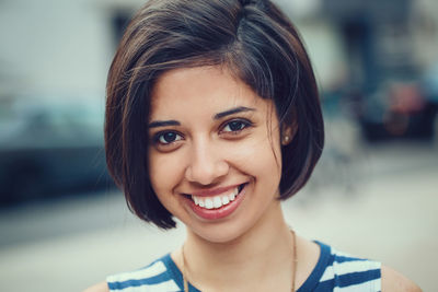 Close-up portrait of smiling young woman