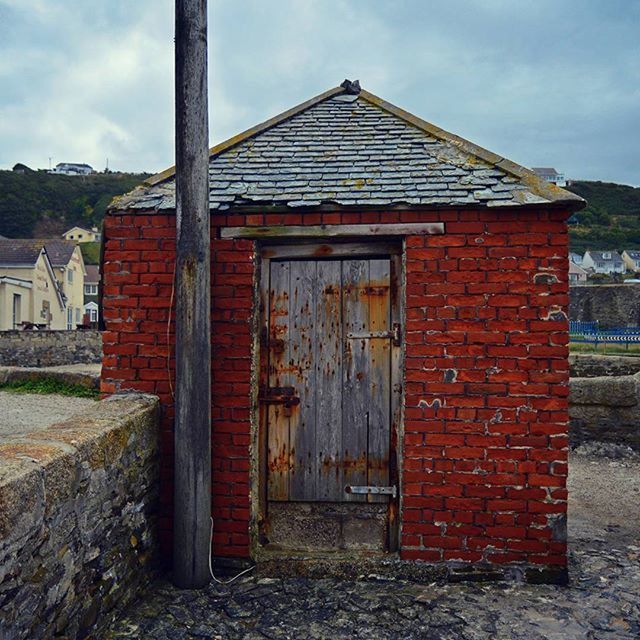 building exterior, architecture, built structure, house, door, sky, closed, red, residential structure, window, old, wood - material, brick wall, safety, entrance, weathered, outdoors, cloud - sky, day, security