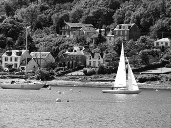 Sailboats in city by building