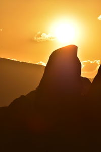 Scenic view of silhouette mountains against sky during sunset