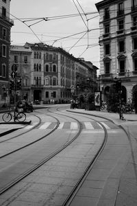 Cars on street in city against clear sky