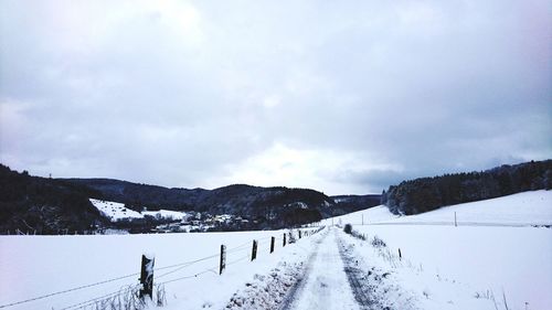 Panoramic view of snow covered landscape against sky