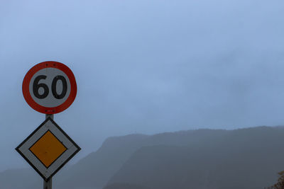 Low angle view of road sign against sky