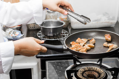 Midsection of man preparing food in kitchen