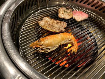 High angle view of fish on barbecue grill