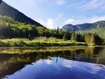 Scenic view of lake and mountains against sky