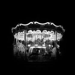 View of ferris wheel against black background