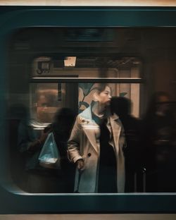 Reflection of woman on train window