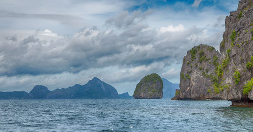 Panoramic view of sea and mountains against sky
