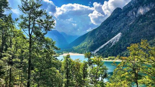 Scenic view of lake and mountains against sky