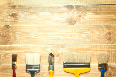 Close-up of wooden table against blue background