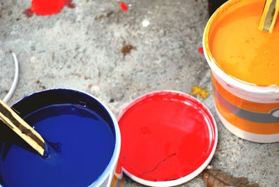 High angle view of blue and yellow paint cans