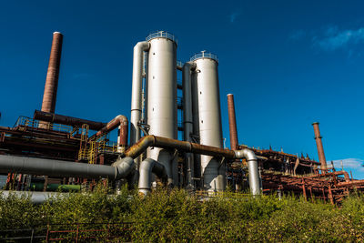 Low angle view of smoke stack against sky