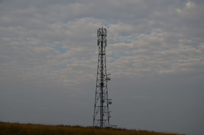 Low angle view of communications tower against sky