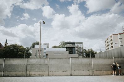 Street by buildings against sky