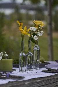 Close-up of yellow flower vase on table