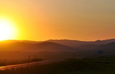 Scenic view of landscape against sky during sunset