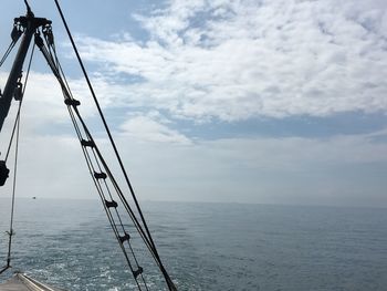 Sailboat in sea against sky