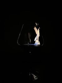 Close-up of illuminated lamp against black background