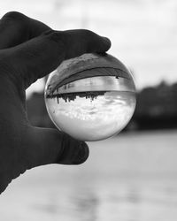 Close-up of hand holding crystal ball