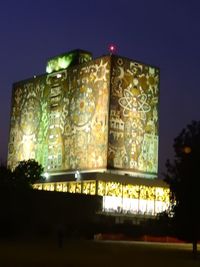 Close-up of illuminated city against sky at night