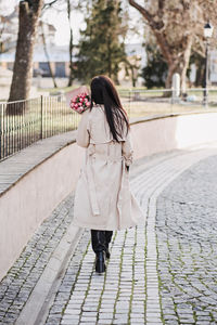 Spring, self love, self care. candid portrait of happy woman with tulips bouquet outdoors