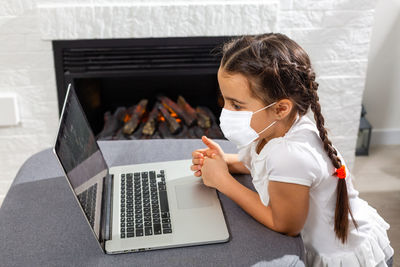 Little kid schoolgirl 12-13 years old in face mask study 