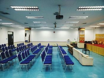 Empty chairs and tables in row