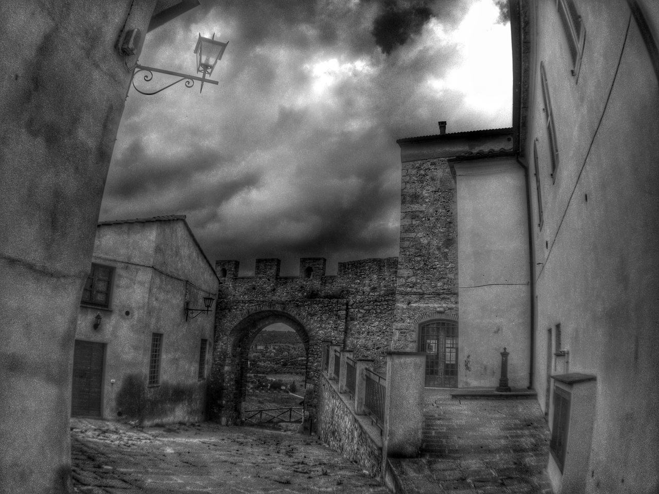 architecture, built structure, building exterior, sky, cloud - sky, arch, low angle view, building, cloudy, old, wall - building feature, history, cloud, day, street, outdoors, abandoned, historic, no people, window