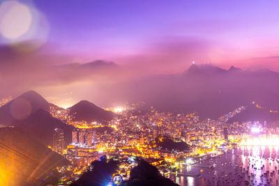 High angle view of illuminated buildings in city at night