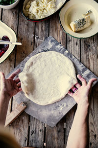 Cropped hands of person preparing food on table