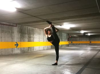 Full length of woman standing in illuminated building