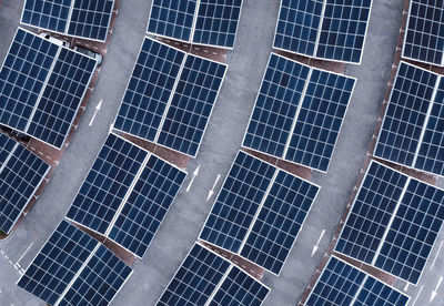 Aerial view of solar panels on a parking lot rooftop