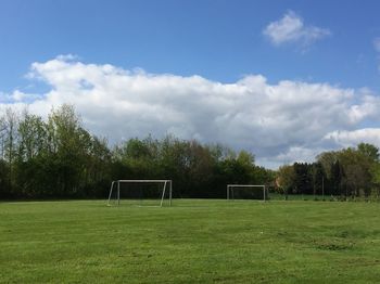 View of soccer field against cloudy sky