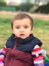 Portrait of cute boy in field