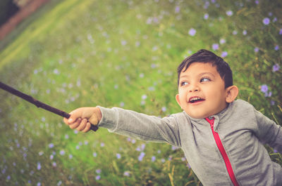 Portrait of cute boy holding plant