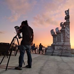 Low angle view of man standing against built structures