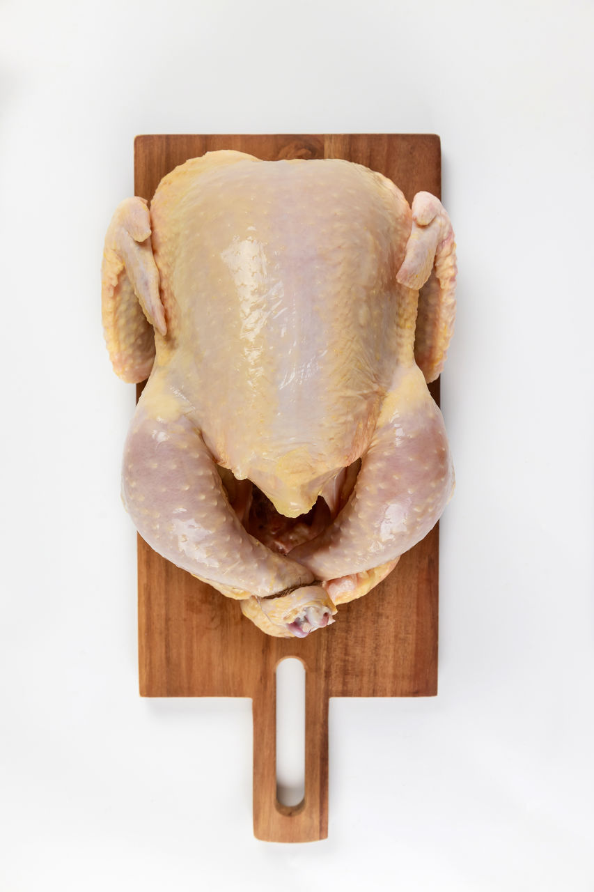 food and drink, food, freshness, studio shot, indoors, wood, healthy eating, wellbeing, white background, cutting board, no people, still life, raw food, directly above, single object, turkey meat, cut out, bread