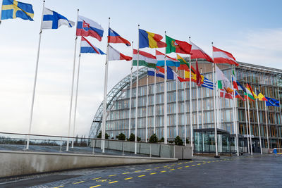 Low angle view of flags against sky