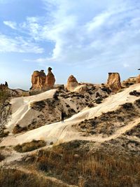 Rock formations on landscape against sky
