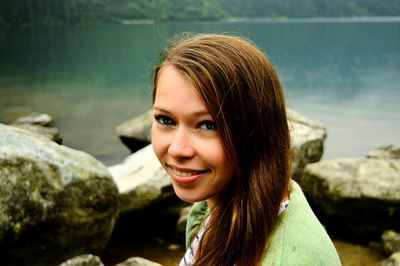 Portrait of smiling woman on rock