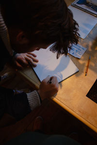 High angle view of woman reading book