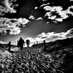 Scenic view of landscape against cloudy sky